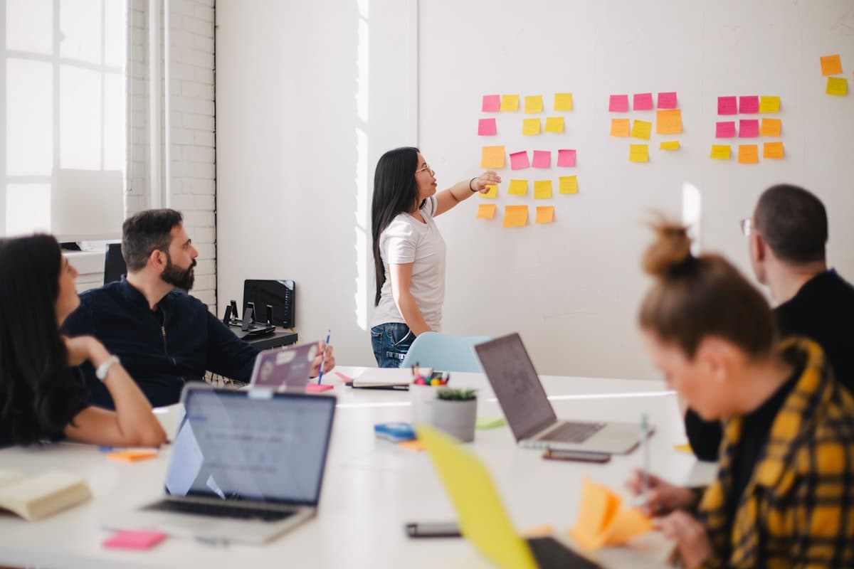 Creative collaborators reviewing design work together at a studio table